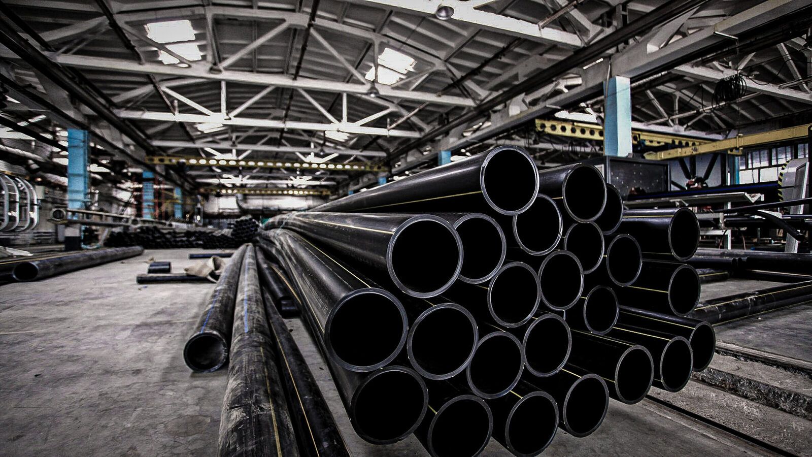 Industrial pipe bundles staged at a manufacturing facility