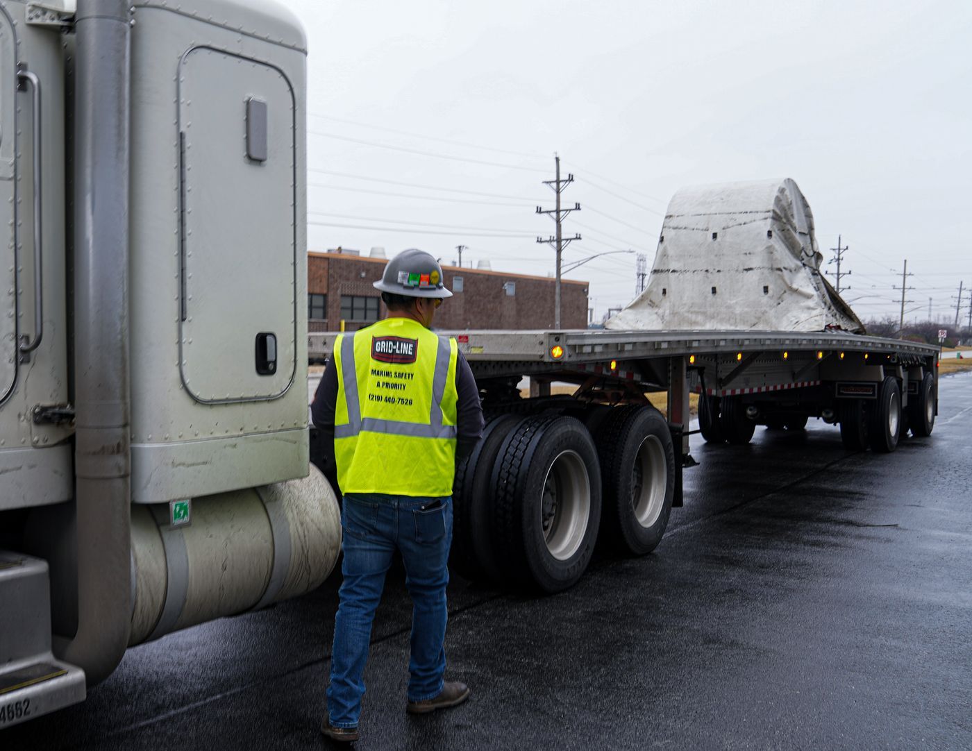 Grid-Line driver walking around a coil load before departure