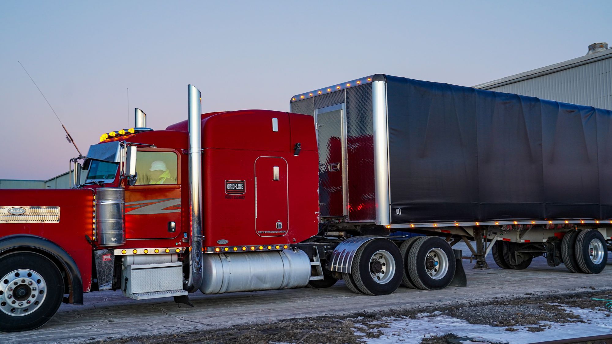 Grid-Line tractor and flatbed at dusk