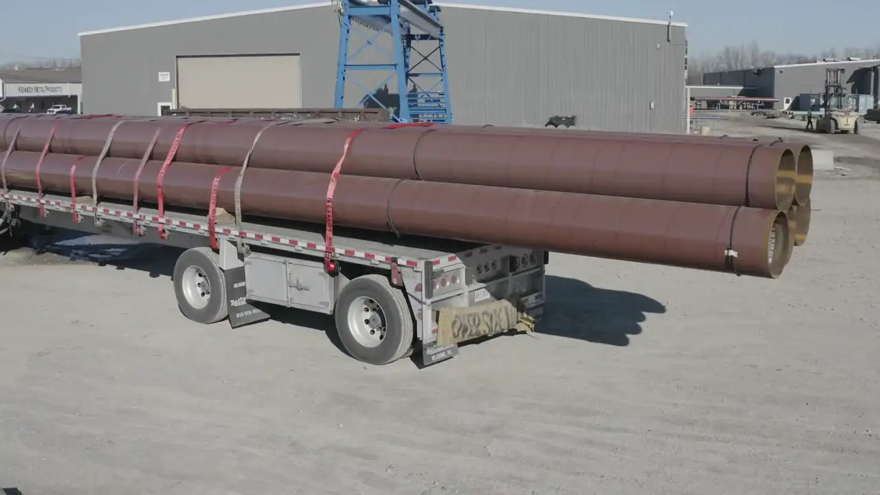 Grid-Line flatbed loaded with pipe, from the air